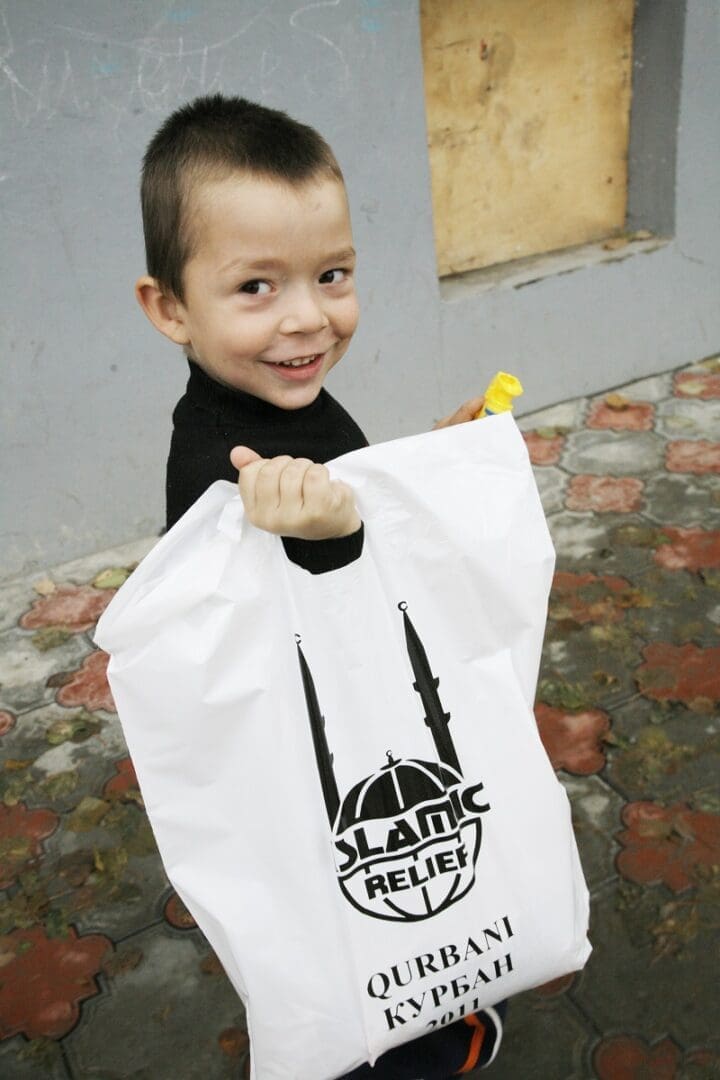 A Chechen boy with his family's Qurbani pack.